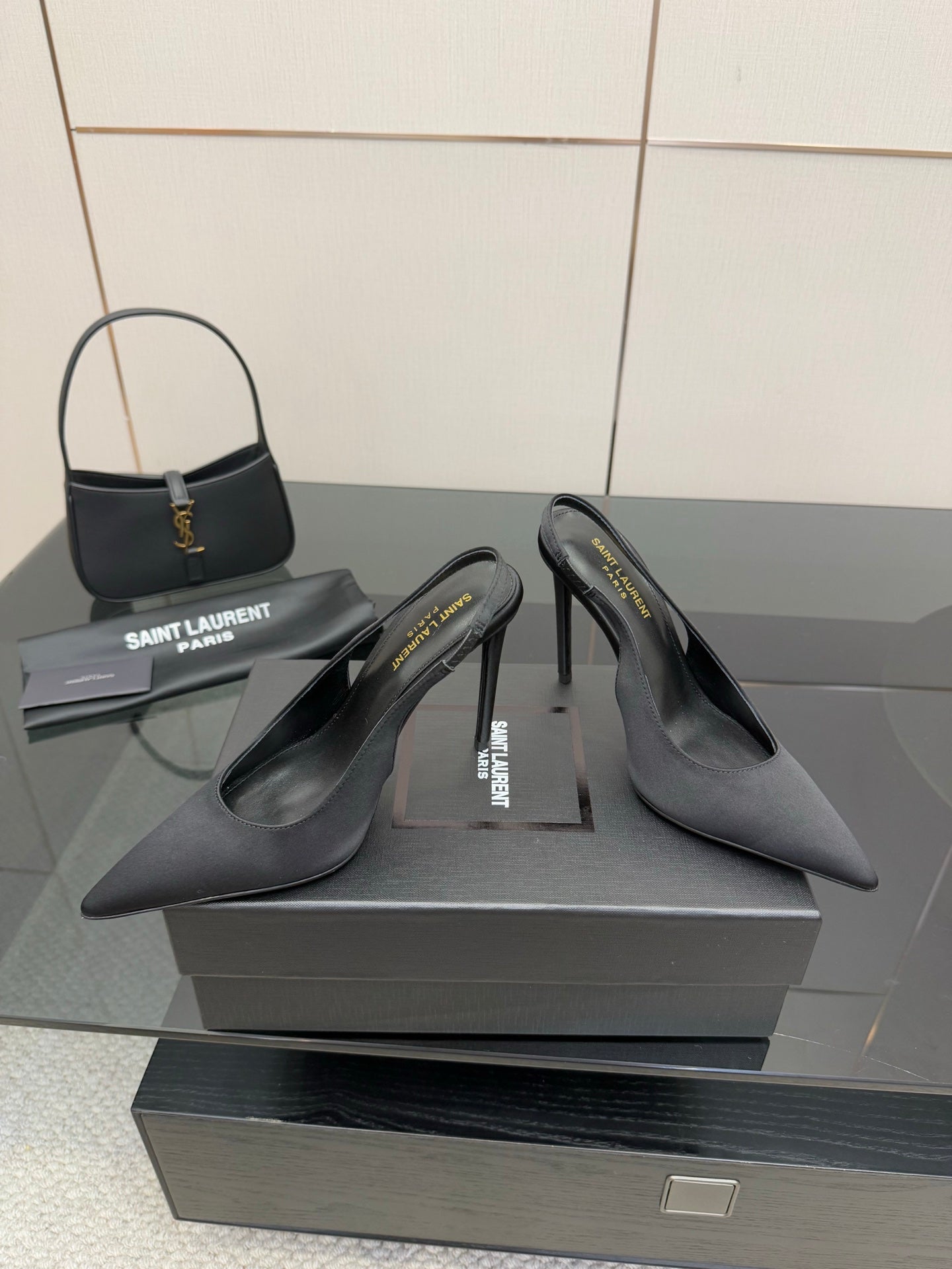 Women’s stiletto heeled pumps, dark leather, heel and toe view