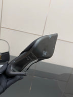 Women’s stiletto heeled pumps, dark leather, outsole and logo area
