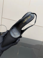 Women’s stiletto heeled pumps, dark leather, insole label shown