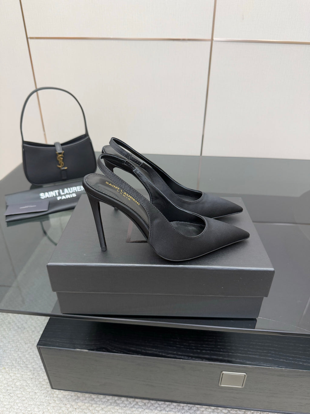 Women’s stiletto heeled pumps, dark leather, side profile