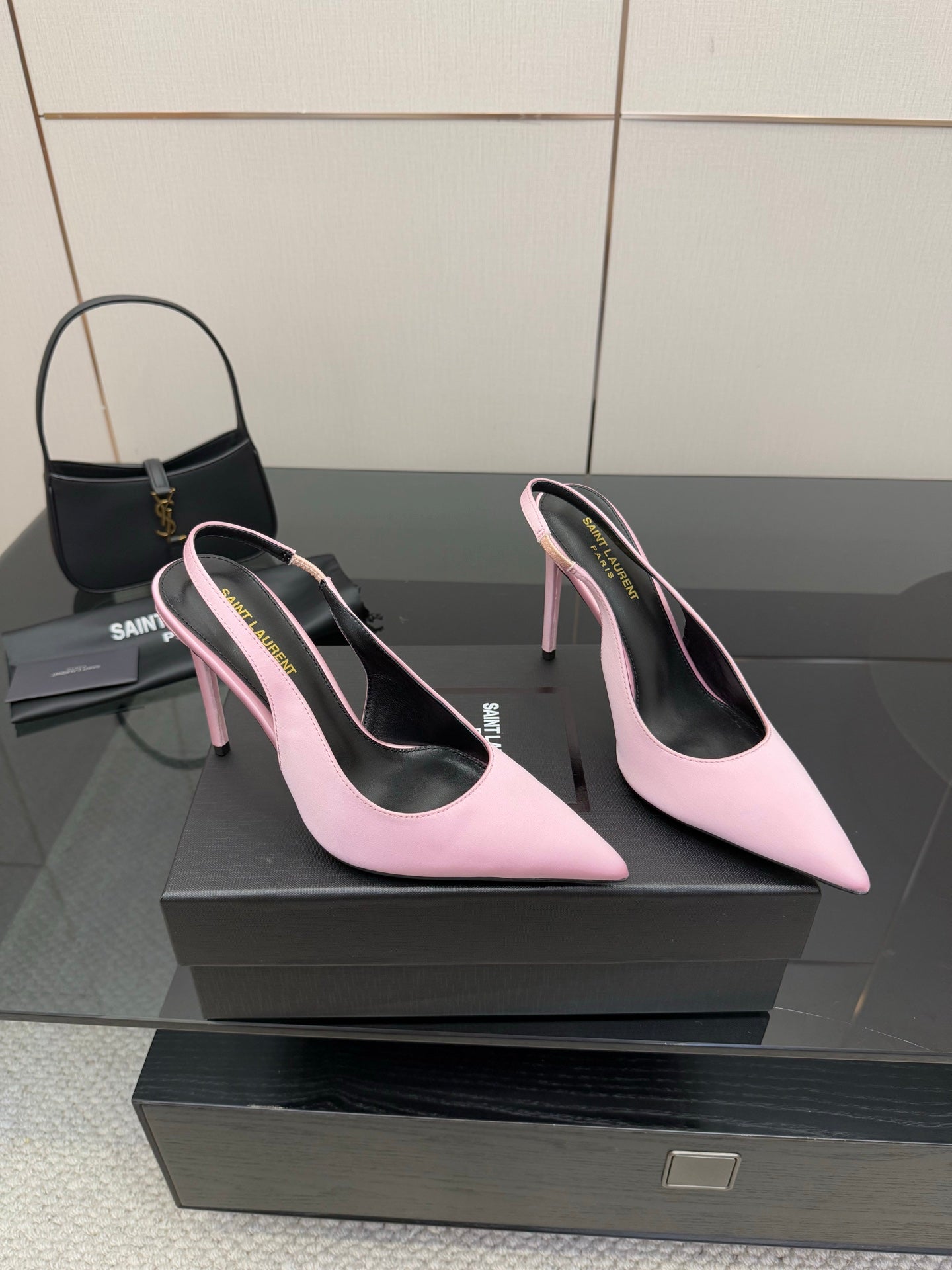 Pink pointed-toe stiletto heels, side view pair with narrow heel and curved toe