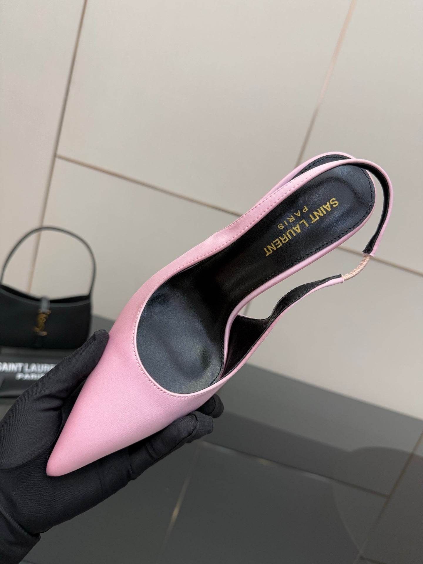 Pink pointed-toe stiletto heel, top view showing black insole with printed text