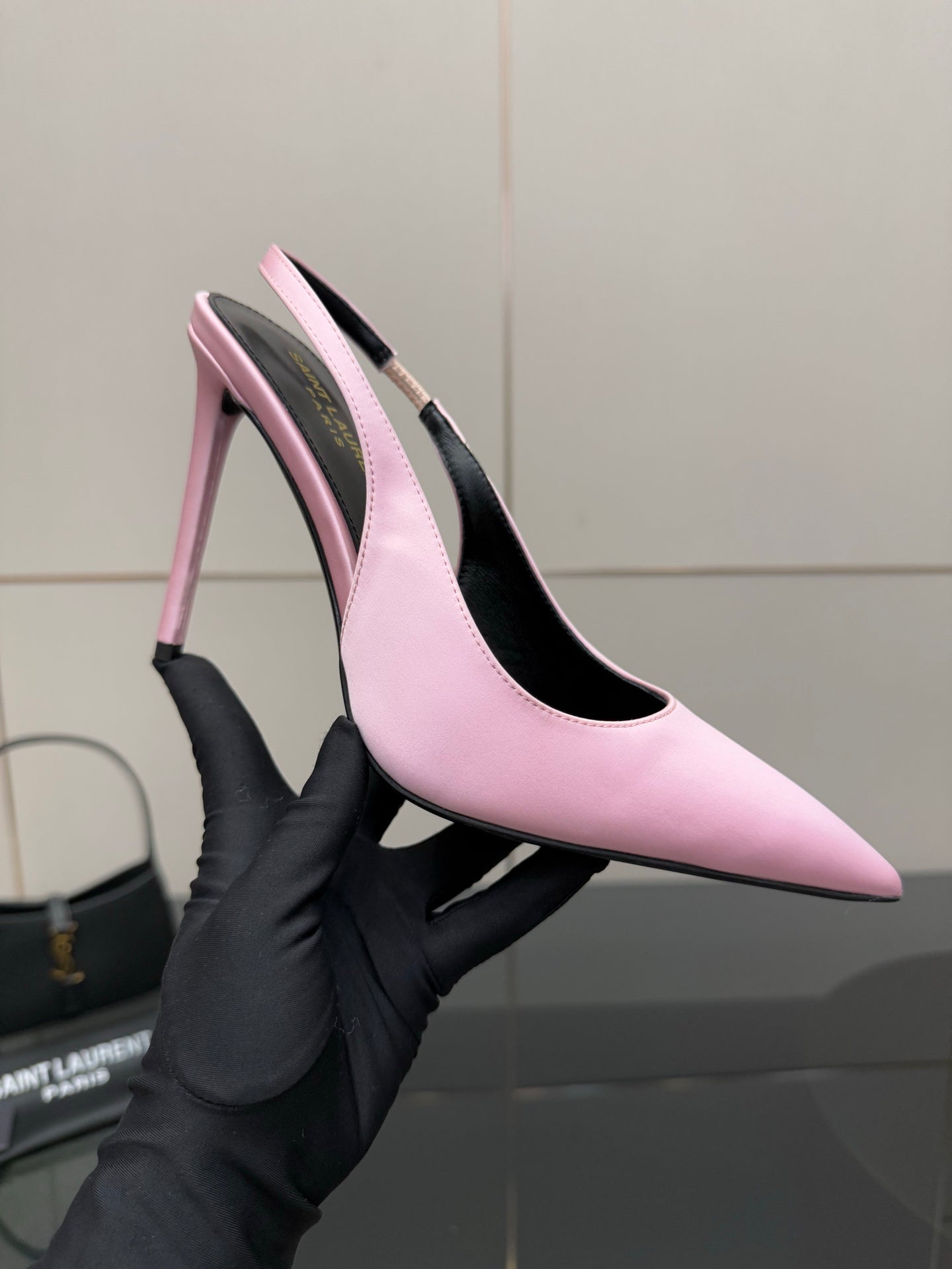 Pink pointed-toe stiletto heel on display, close-up with black insole and narrow heel