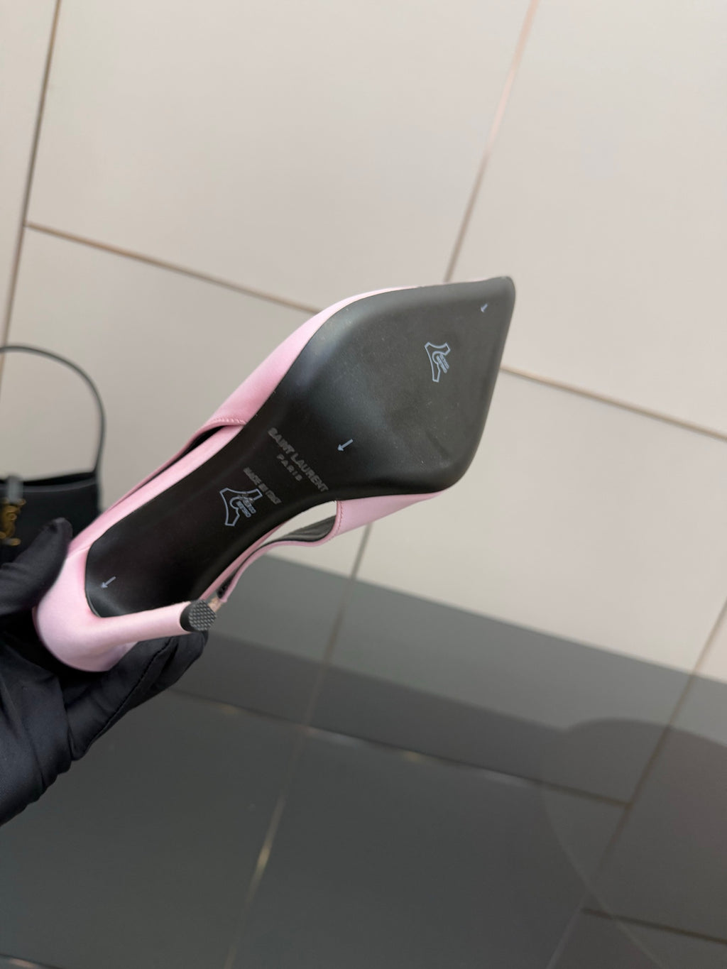 Pink stiletto heel close-up, outsole and pointed heel tip with dark insole branding