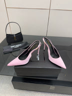 Pink pointed-toe stiletto heels, three-quarter view with black interior and branding