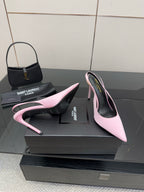 Pink pointed-toe stiletto heels, angled view showing outsole edge and stiletto heel