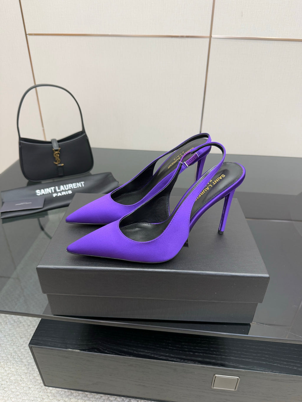 Purple pointed-toe stiletto pumps, side view with thin high heels.