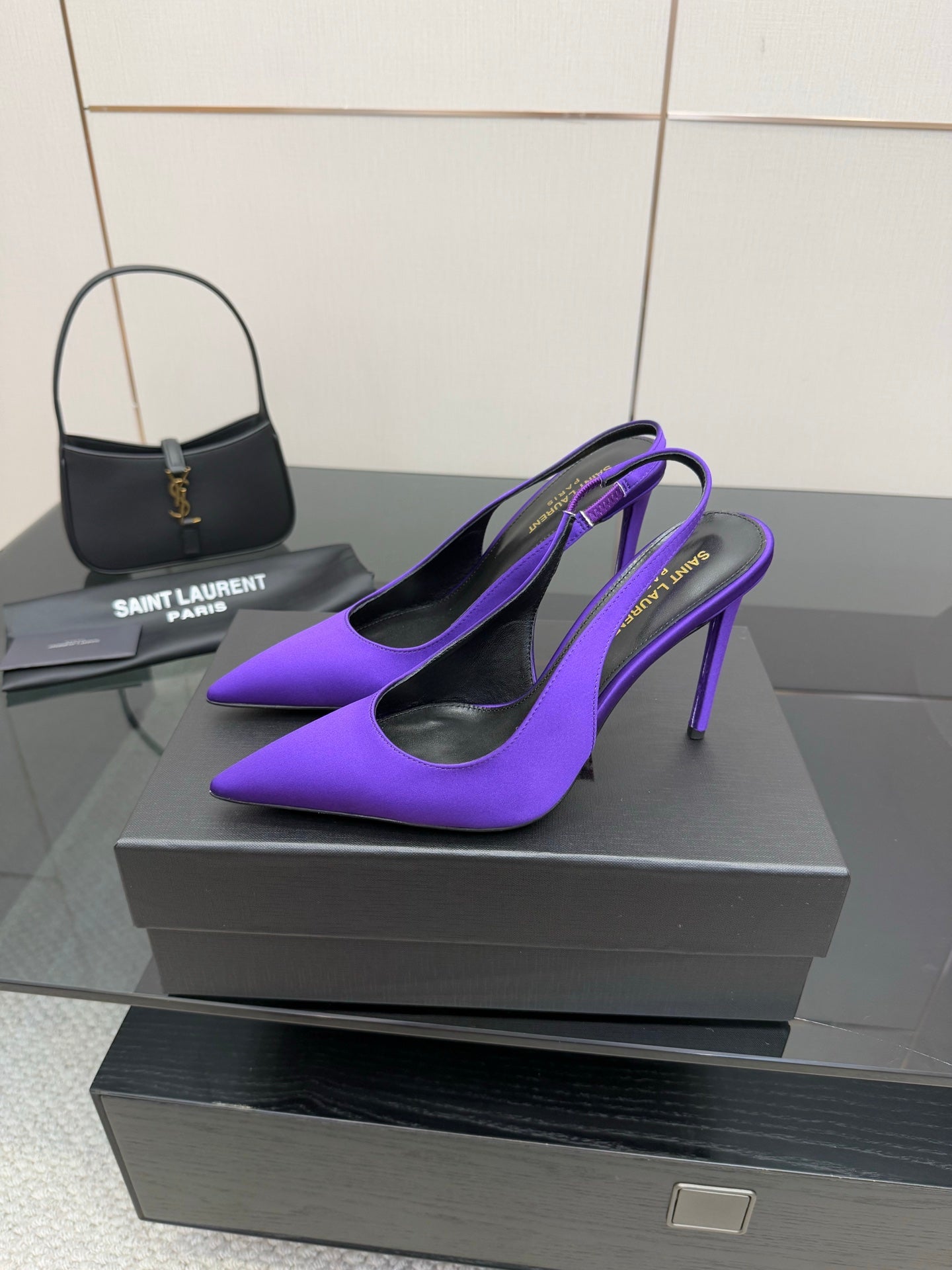 Purple pointed-toe stiletto pumps, side view with thin high heels.