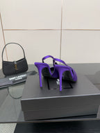 Purple pointed-toe stiletto pumps, rear view showing heel and back profile.