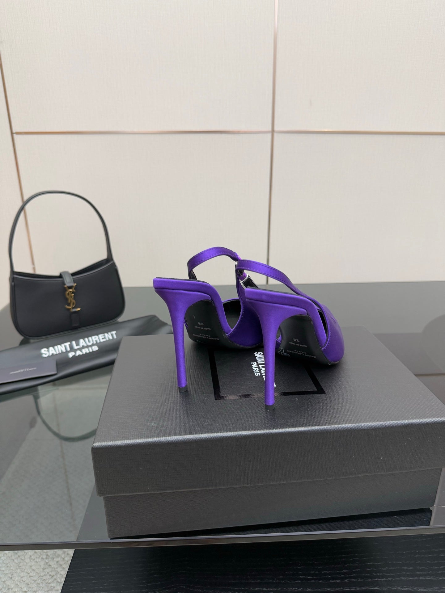 Purple pointed-toe stiletto pumps, rear view showing heel and back profile.