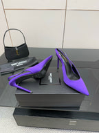 Purple pointed-toe stiletto pumps, overlapping toe and heel detail on box.