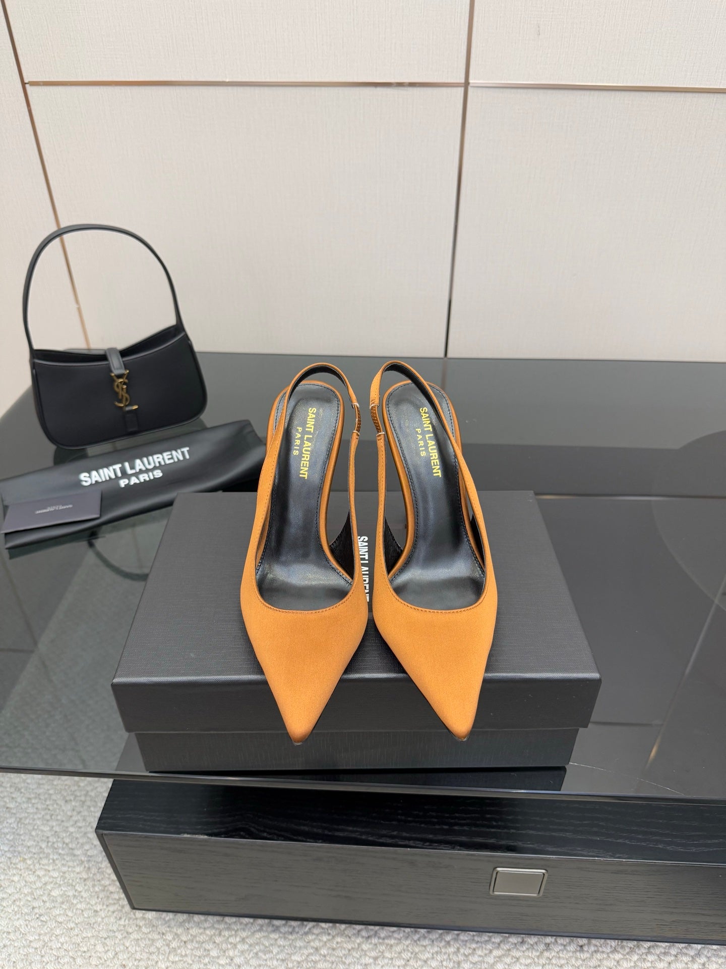 Orange pointed-toe high-heel pumps with stiletto heel and branded insole