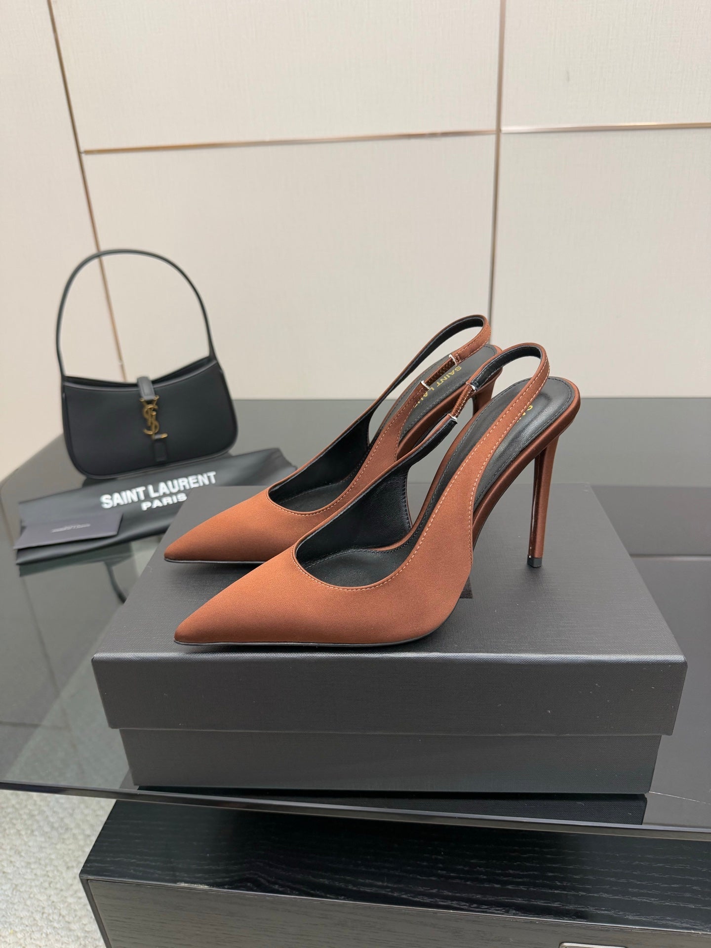 Two-tone pointed-toe slingback pumps on black and gray insole, brown with black panels