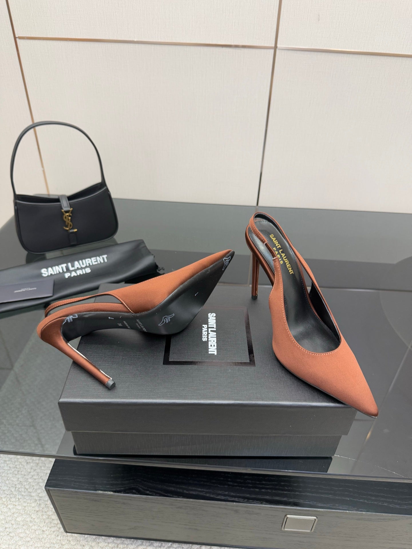 Two-tone pointed-toe slingback pumps with stiletto heel, brown upper and black trim