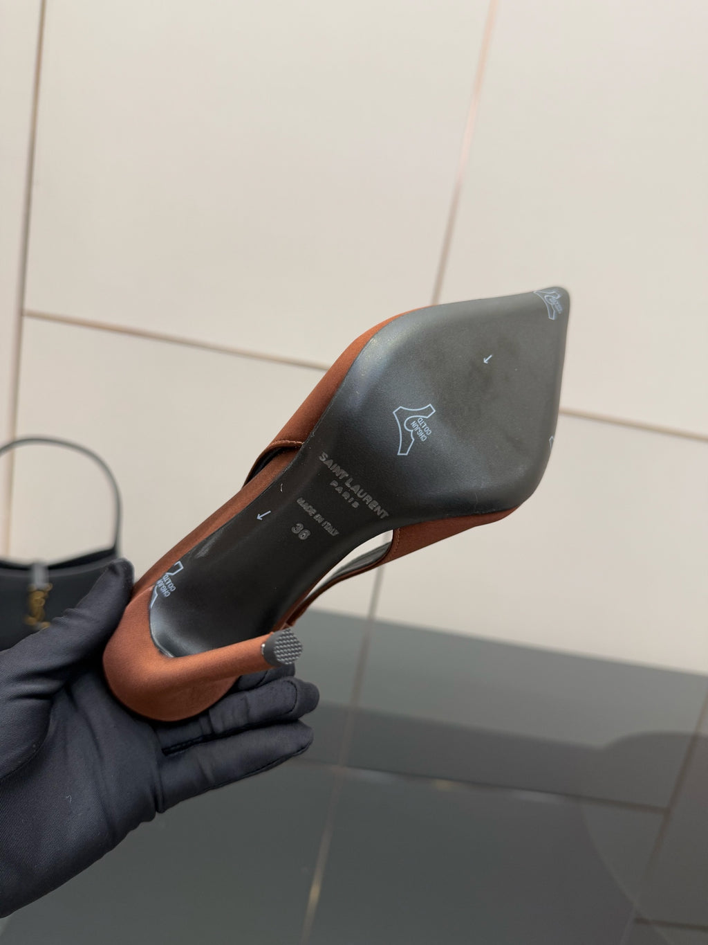 Two-tone pointed-toe slingback pump underside, brown edge with black heel counter