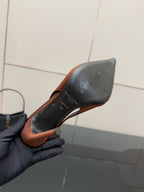 Two-tone pointed-toe slingback pump underside, brown edge with black heel counter