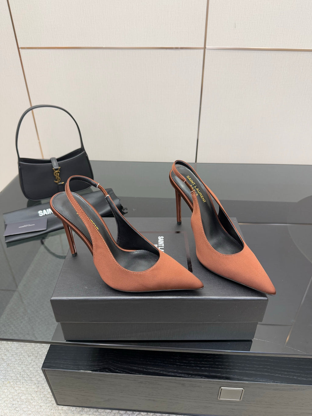 Pair of two-tone pointed-toe slingback pumps with stiletto heels, brown and black