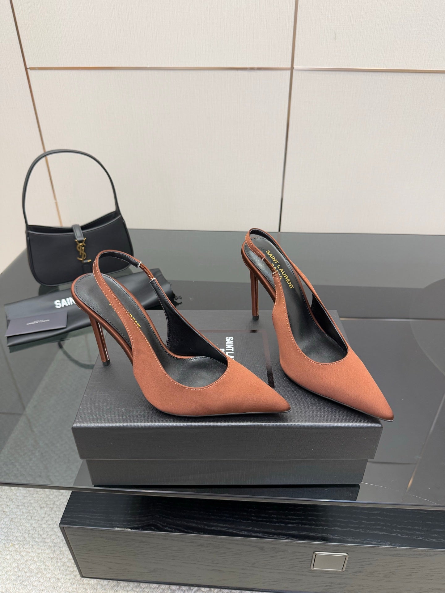 Pair of two-tone pointed-toe slingback pumps with stiletto heels, brown and black
