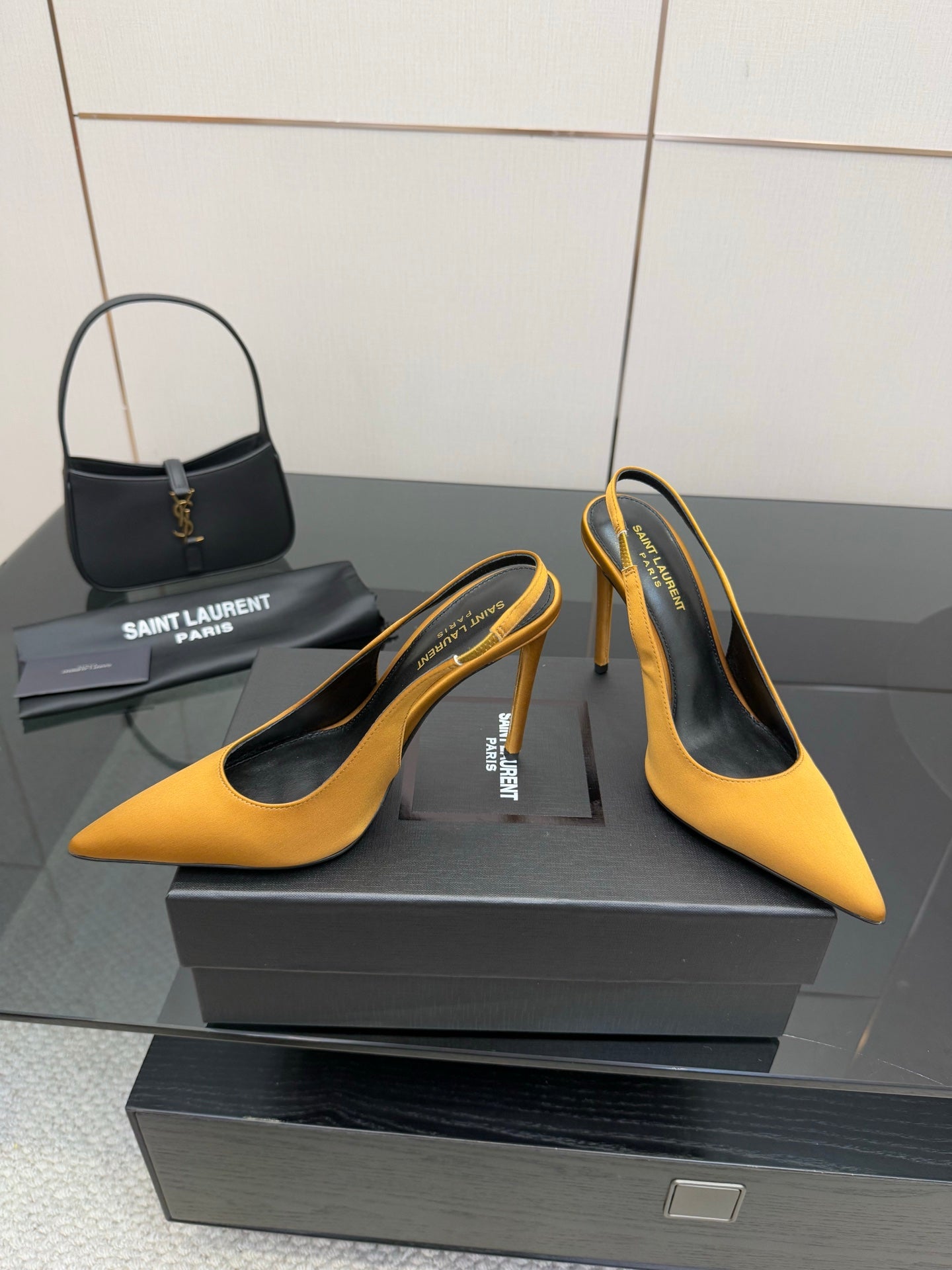 Yellow pointed-toe stiletto pumps, curved slingback strap and black interior