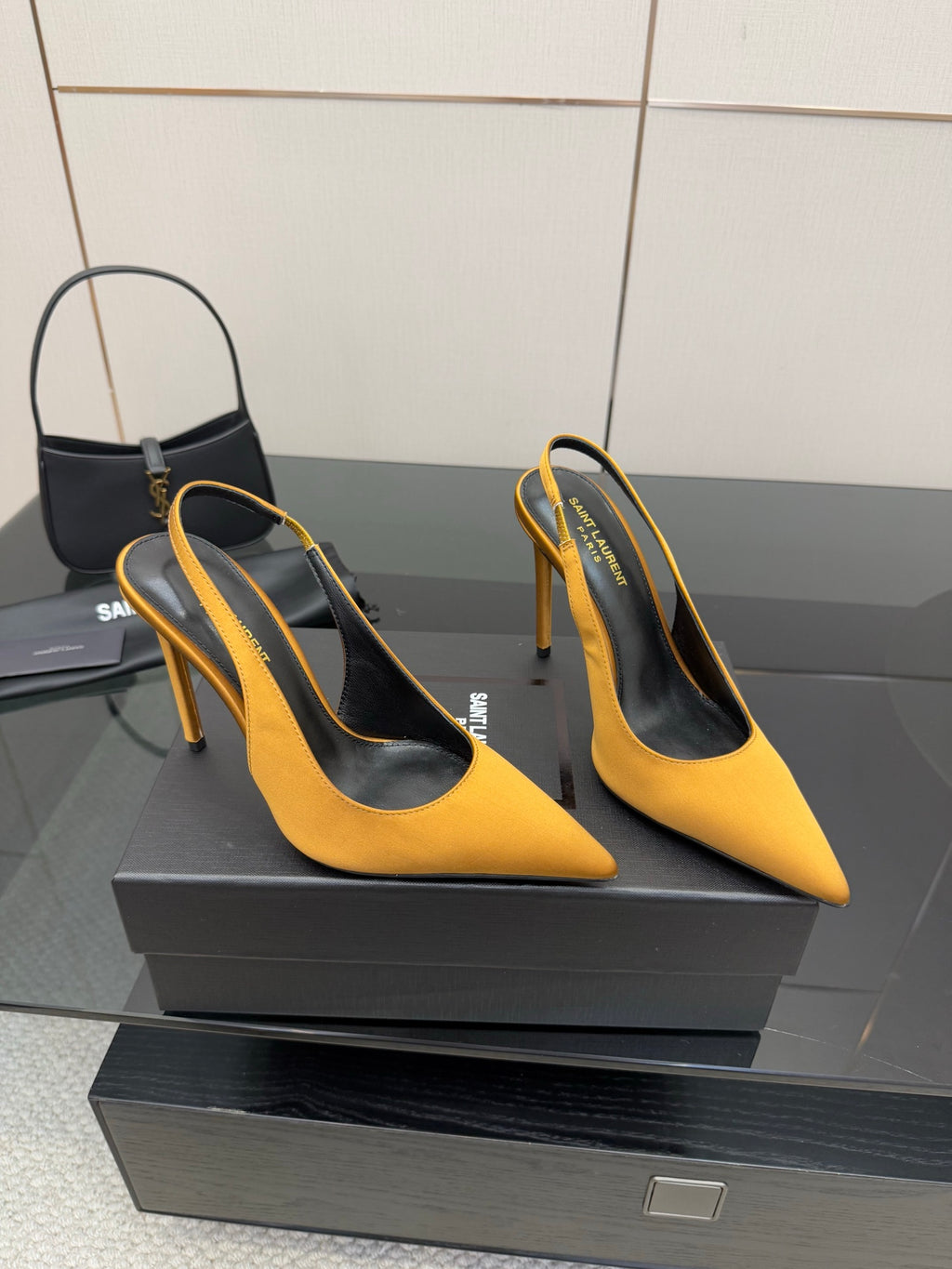 Pair of yellow pointed-toe high heels with slim stiletto heel and black insole