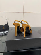 Back view of yellow stiletto pumps showing heel and slingback strap