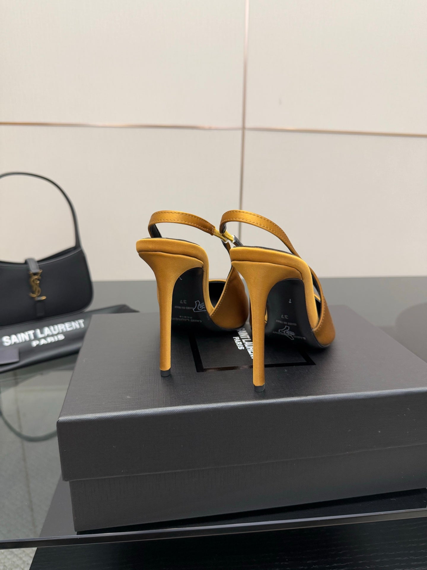 Back view of yellow stiletto pumps showing heel and slingback strap