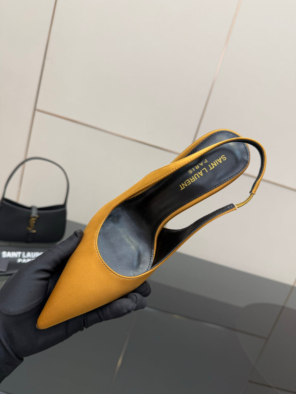 Yellow pointed-toe pump shown from above; black insole with lettering