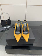 Yellow pointed-toe high-heel pumps with slim stiletto heels and slingback strap
