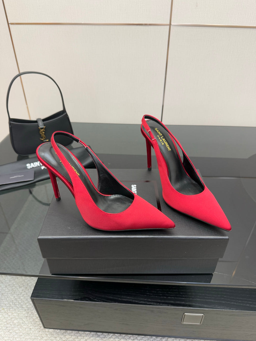 Ladies red high-heel pumps with pointed toes and stiletto heels, angled view