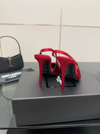 Ladies red stiletto pumps with pointed toes, showing heel backs and straps