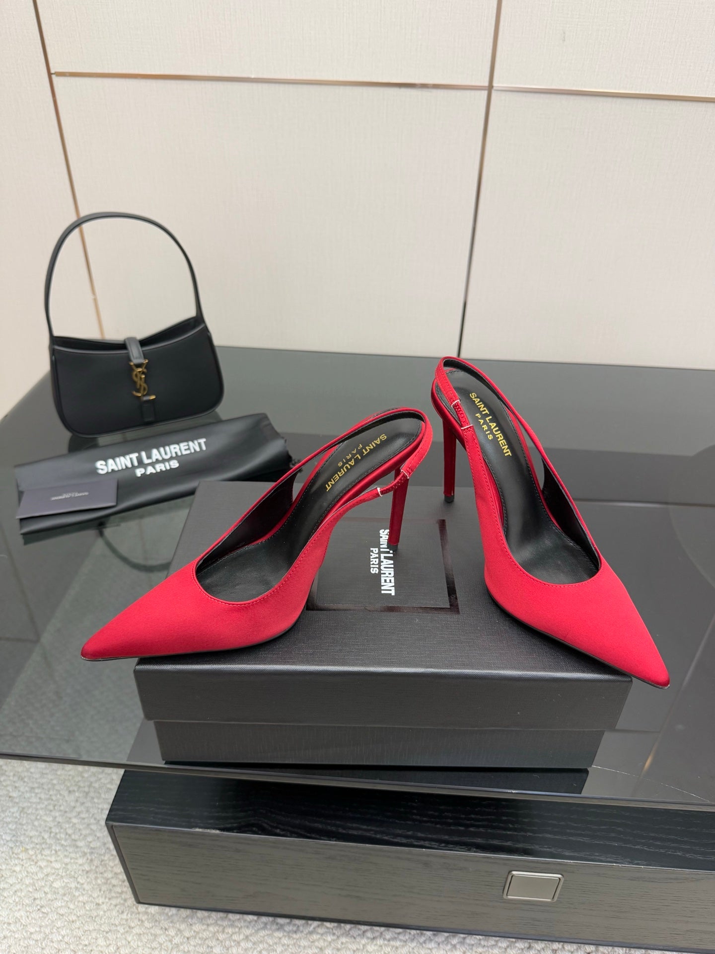 Ladies red pointed-toe stiletto pumps with black lining, heel and vamp detail