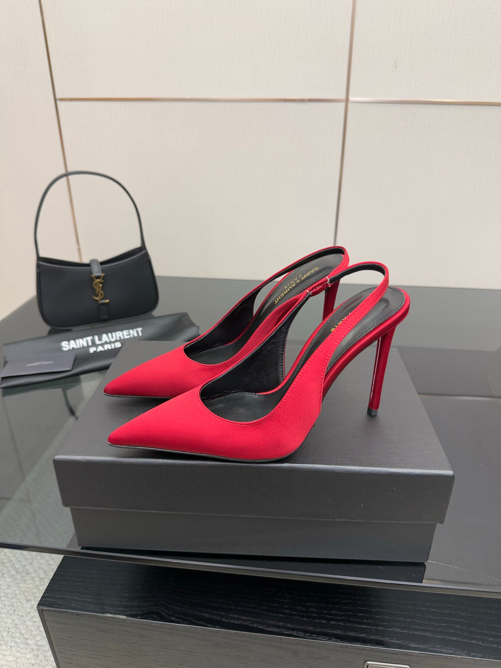 Ladies red pointed-toe stiletto pumps with black lining, side view