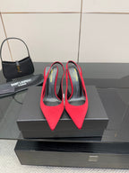 Ladies red high-heel pumps with pointed toes and stiletto heels, black interior