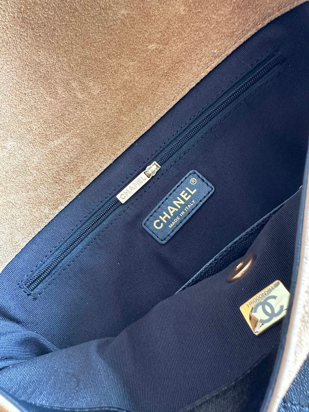 Designer bag interior pocket with blue lining and CHANEL brand label