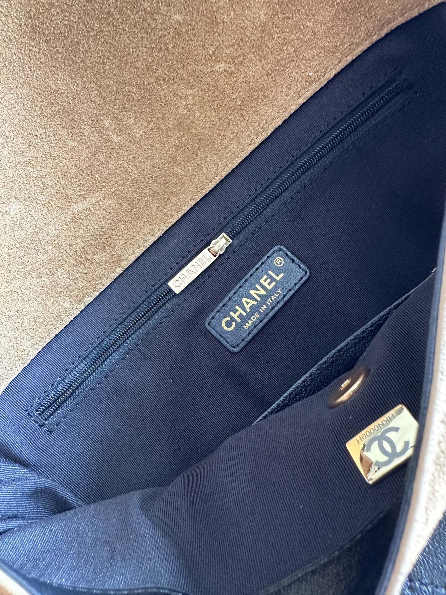 Designer bag interior pocket with blue lining and CHANEL brand label