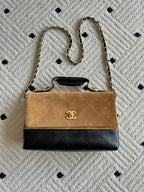 Chanel bag with quilted black bottom, tan flap and gold chain handle
