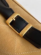 Designer bag strap with gold buckle and engraved 'CHANEL' on black leather