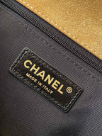 Designer bag interior label reading CHANEL and MADE IN ITALY on black lining