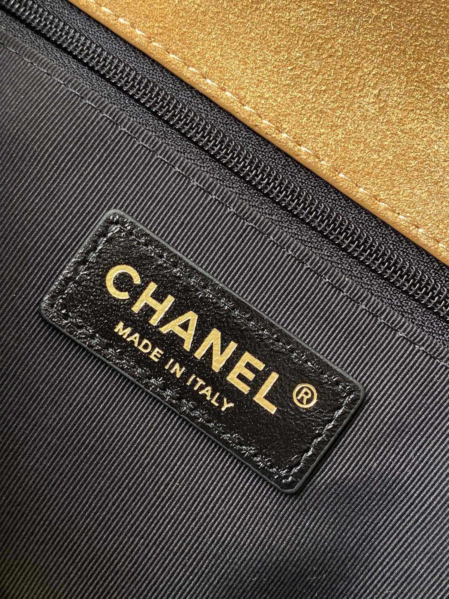 Designer bag interior label reading CHANEL and MADE IN ITALY on black lining
