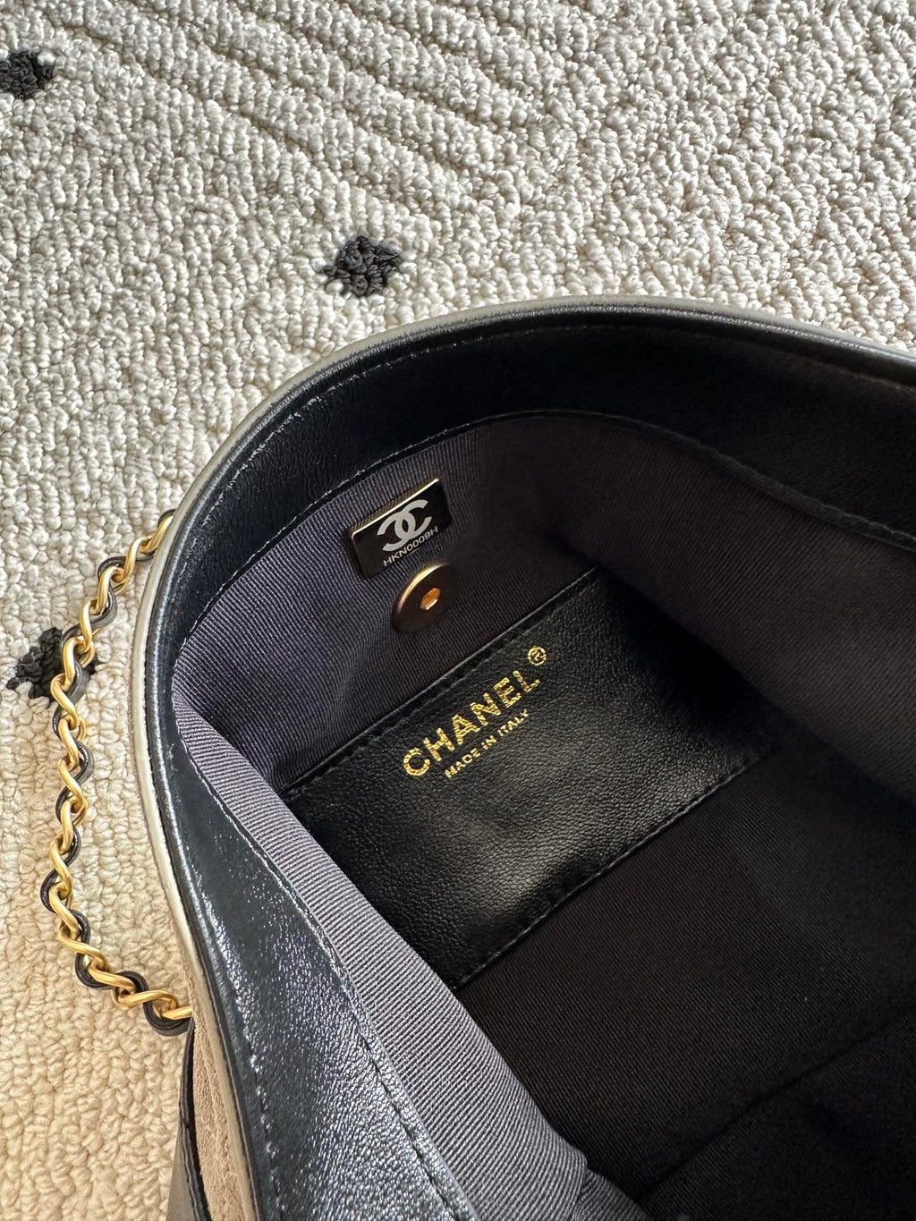 Chanel bag interior with black lining and CHANEL label on side panel