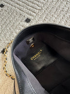 Chanel bag interior with black lining and CHANEL label on side panel