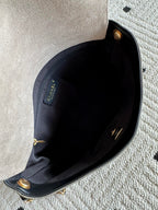Chanel bag interior view with dark lining and gold-tone hardware at top