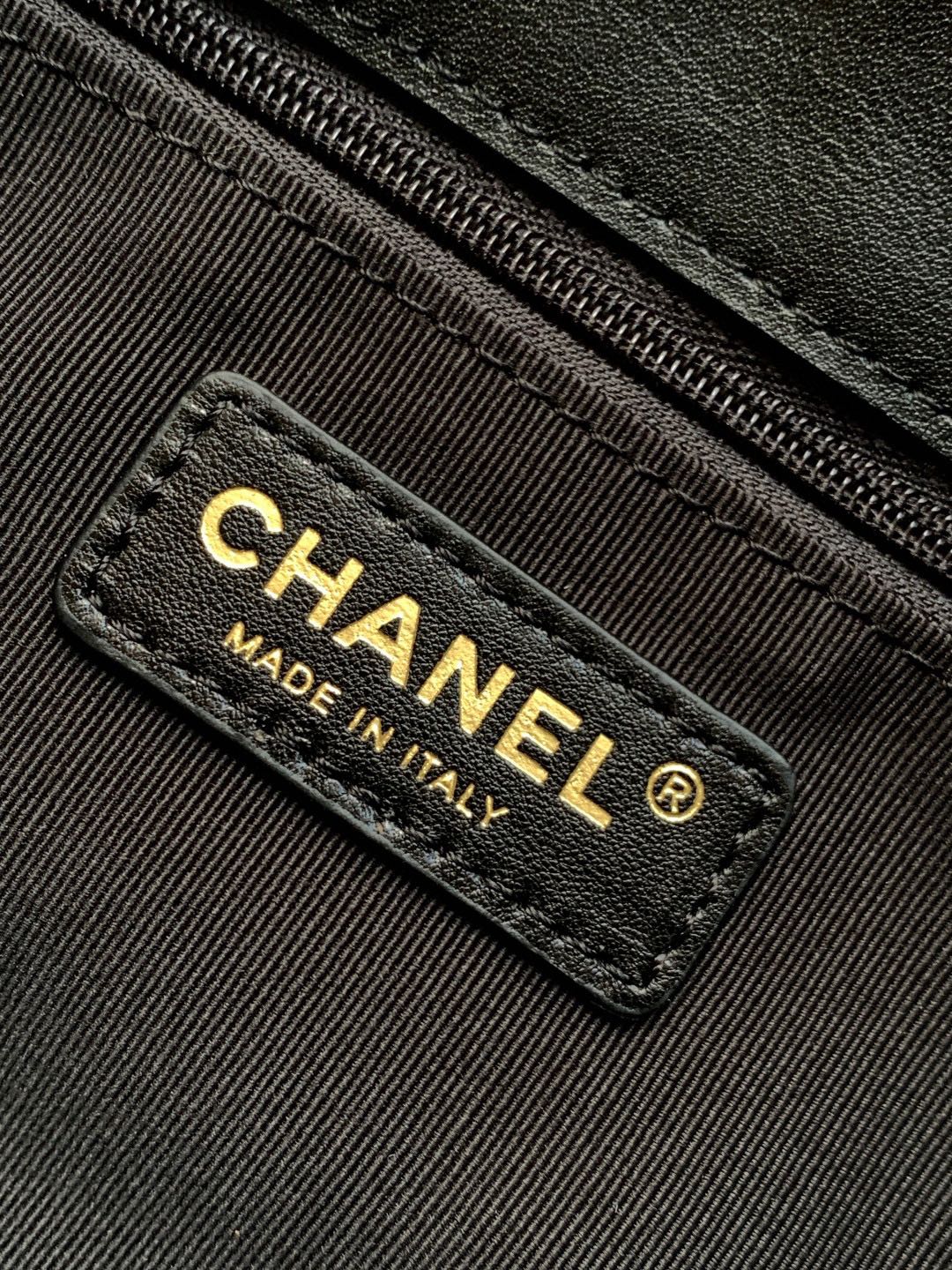 Chanel bag label reading CHANEL MADE IN ITALY on black leather