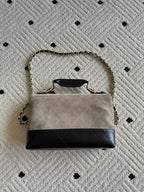 Chanel bag with chain strap, top flap open, beige and black two-tone design