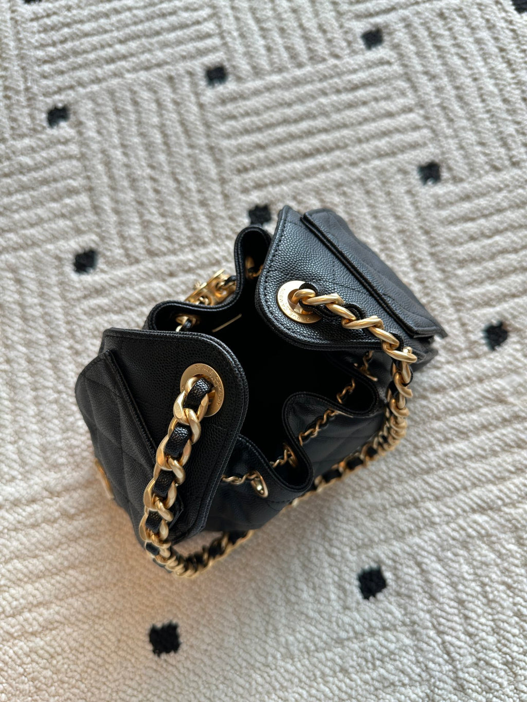 Chanel bag, black leather bucket with gold chain handles and quilted front