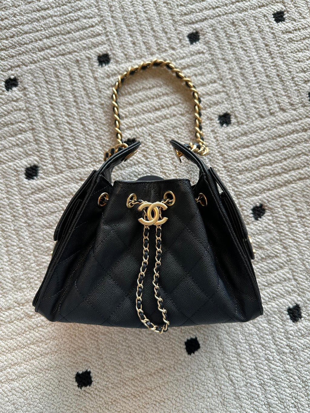 Chanel bag, black leather quilted bucket style with gold chain top handles