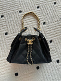 Chanel bag, black leather quilted bucket style with gold chain top handles
