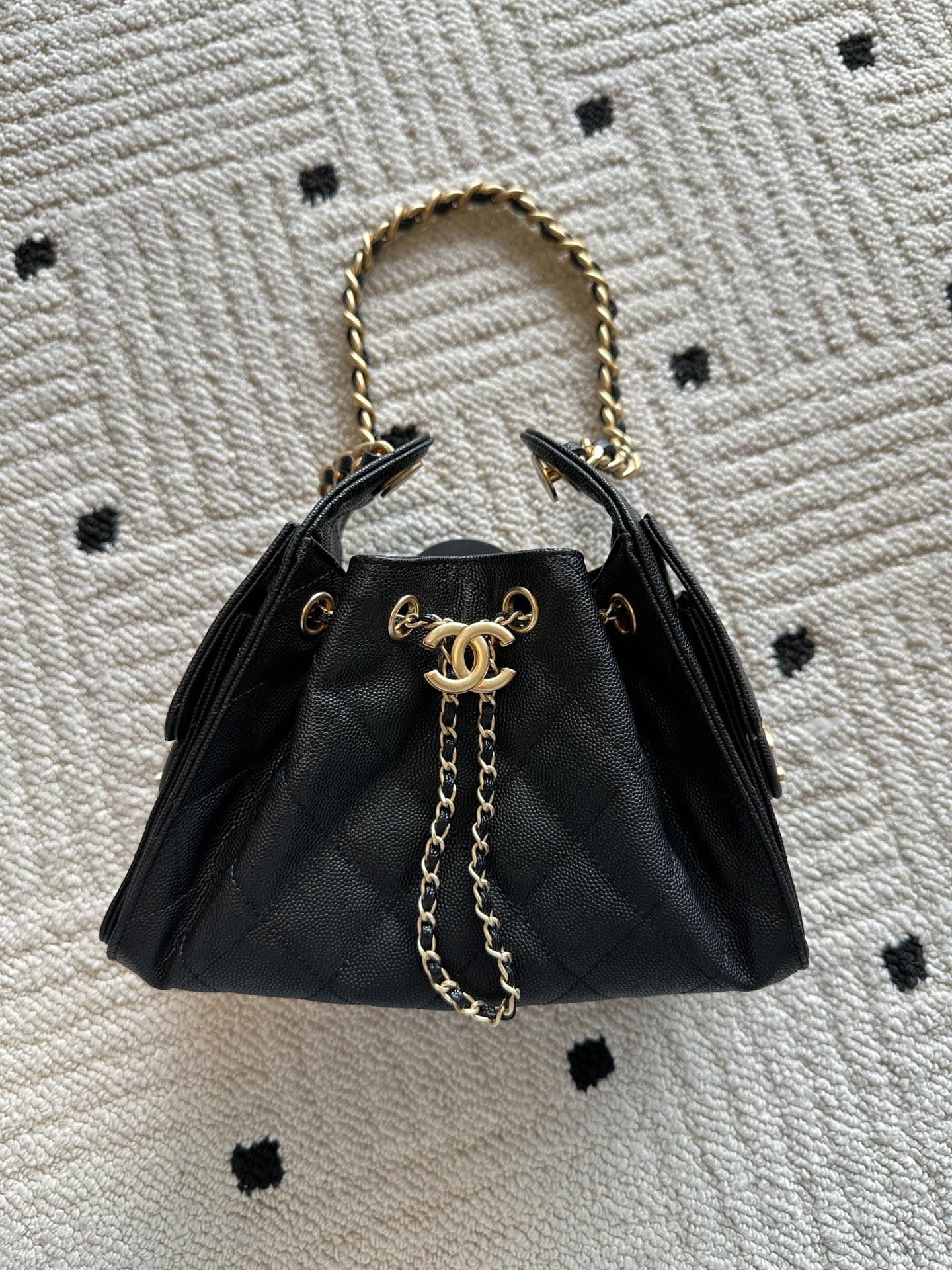 Chanel bag, black leather quilted bucket style with gold chain top handles