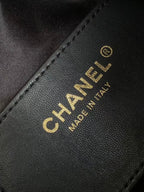 Chanel bag label, CHANEL logo and MADE IN ITALY on black leather