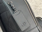 Close-up of dark green leather-look zipper track and embossed logo patch.